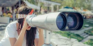 woman looking through binoculars
